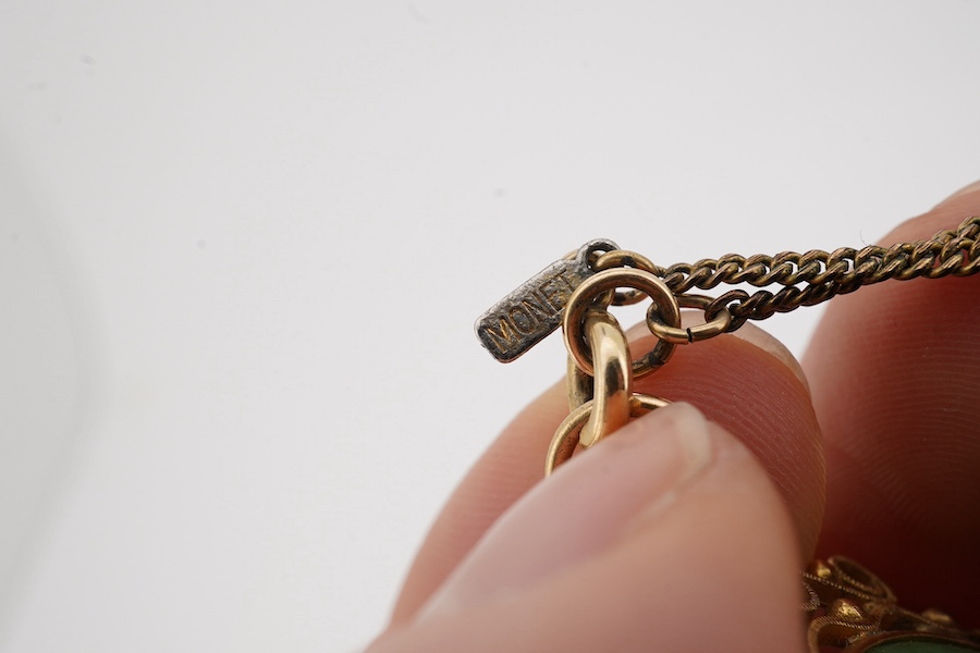 A Chinese yellow metal mounted carved jade 'Shou Fu' pendant, 36mm, on a gilt metal chain. Condition - fair to good